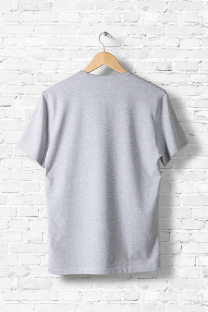 istock Blank Grey T-Shirt Mock-up hanging on white wall, rear side view . Ready to replace your design 809182044