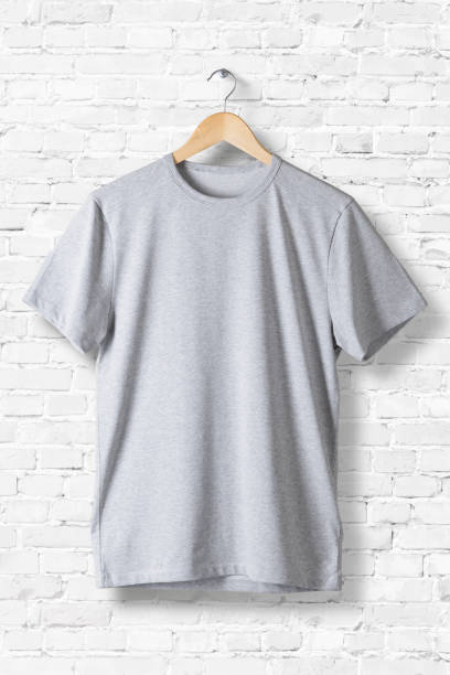 istock Blank Grey T-Shirt Mock-up hanging on white wall, front side view . Ready to replace your design 809188626