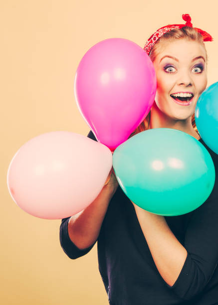 istock Smiling crazy girl having fun with balloons. 809228476