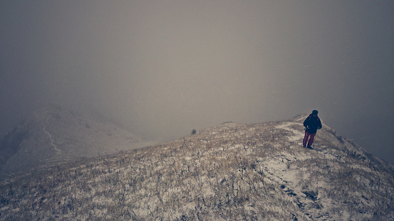 Unrecognizable person hiking in snow in Slovenian Alps