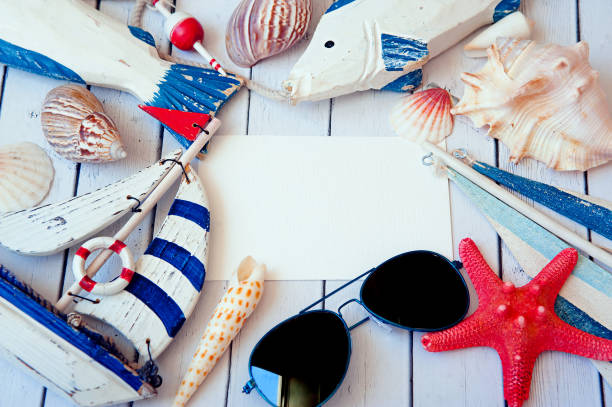 istock Summer holiday background. Sea card with ship, sand, shells and starfish on white background top view. Vacation season. Copy space 809260906