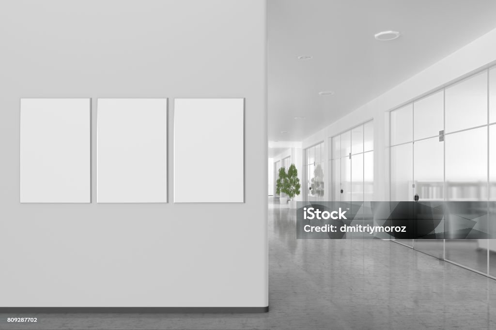 Blank poster on the wall in modern office interior Three blank posters on the wall in bright office interior with clipping path around banner. 3d illustration Office Stock Photo