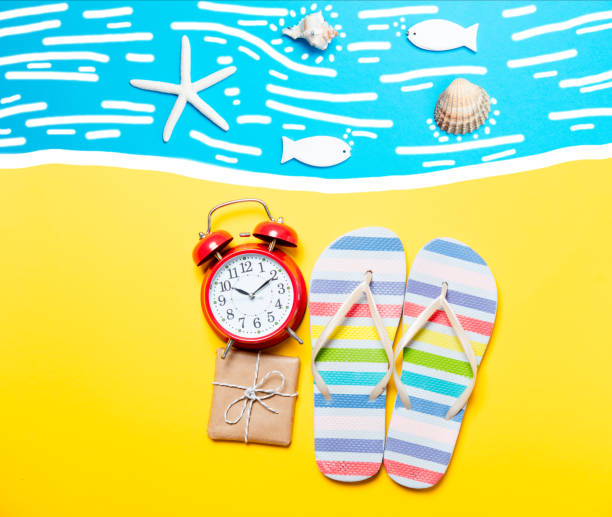 istock Summertime flip-flops and alarm clock with gift 809307194