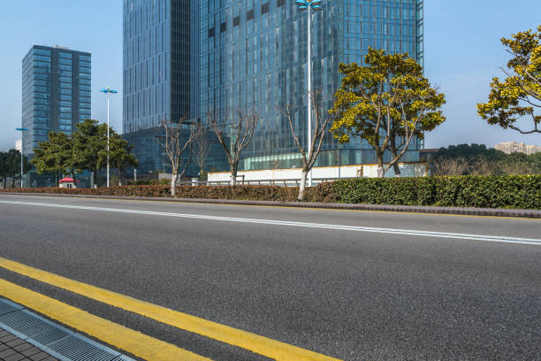 istock Clean asphalt road with modern building 809310266