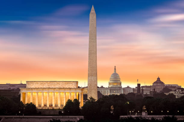 New Dawn over Washington New Dawn over Washington - with 3 iconic monuments illuminated at sunrise: Lincoln Memorial, Washington Monument and the Capitol Building. national monument stock pictures, royalty-free photos & images