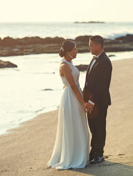 istock Just married couple on ocean beach 809369418