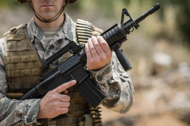 istock Confident military soldier standing with rifle 809374758