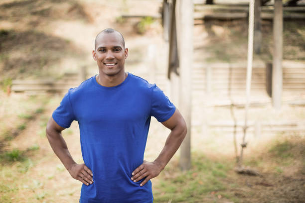 istock Portrait of fit man standing with hands on hip during obstacle course 809389770