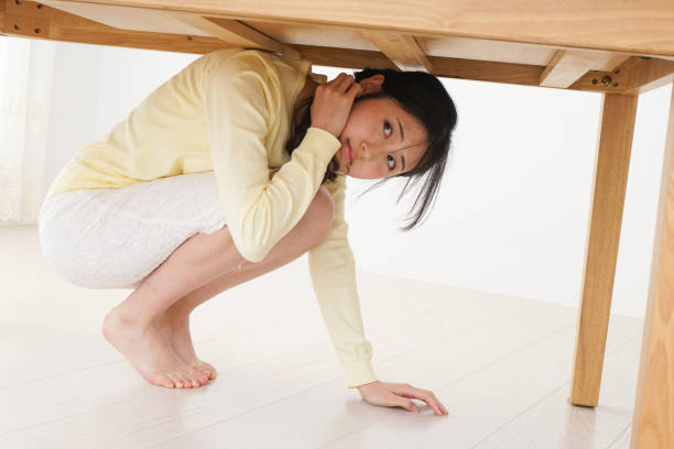 istock Young woman saving from an earthquake 809413606