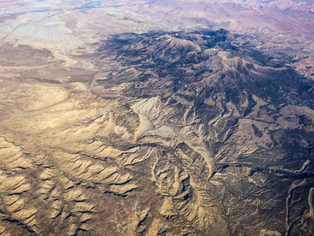 istock View from the plane window when flying over mountain range, canyons and valleys 809476128