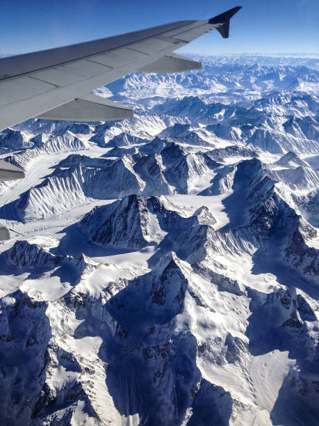 istock View from the plane window when flying over snowcapped mountains in Himalayan region 809476342