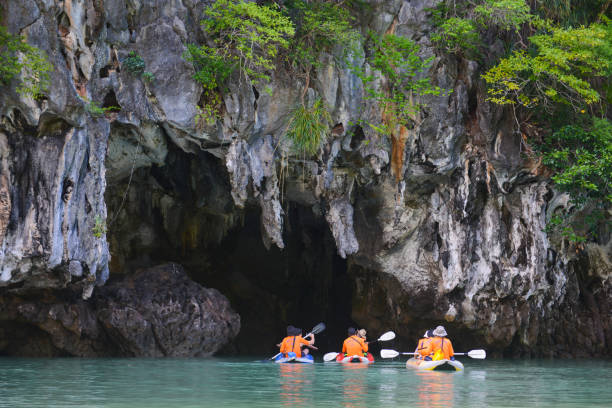 traveller are kayaking to see sighting in Phang-nga Thailand -15 january 2017 :: traveller are kayaking to see sighting in Phang-nga , Thailand phang nga bay stock pictures, royalty-free photos & images