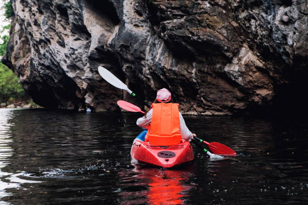 istock Summer vacation - Back view of traveller kayaking on river 809527746
