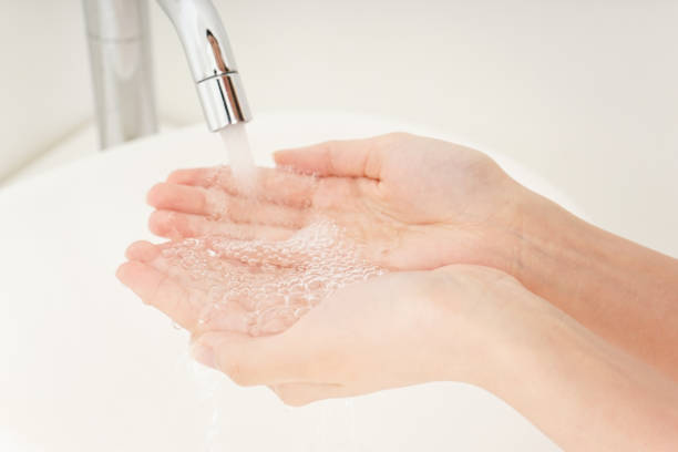 istock Young woman washing face 809531766