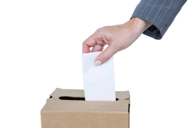 istock Businessman putting ballot in vote box 809538948
