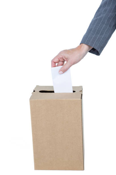 istock Businessman putting ballot in vote box 809541254