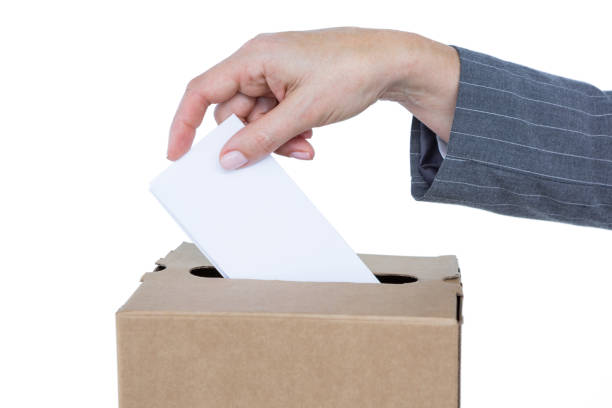 istock Businessman putting ballot in vote box 809543660
