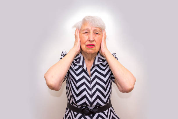 istock Senior Woman With Head In Hands Looking Weary 809558032