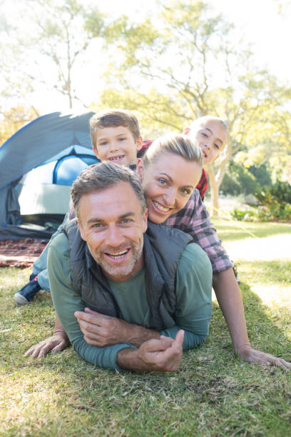 istock Family stacking on each other outside the tent 809608124