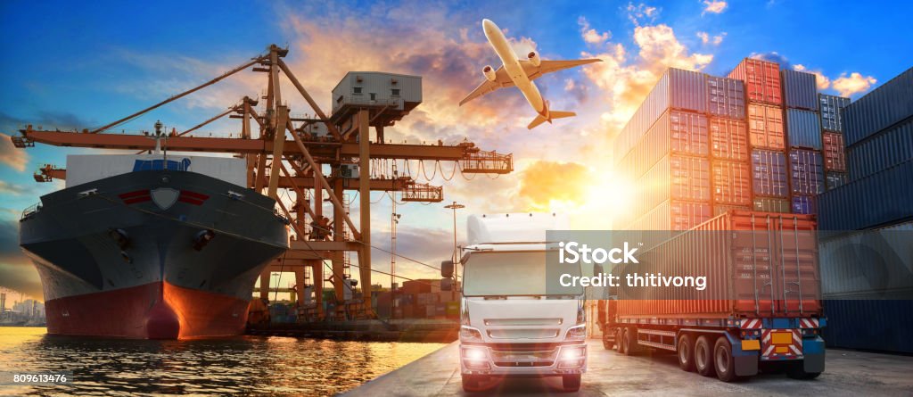 Logistics and transportation of Container Cargo ship and Cargo plane with working crane bridge in shipyard Logistics and transportation of Container Cargo ship and Cargo plane with working crane bridge in shipyard at sunrise, logistic import export and transport industry background Freight Transportation Stock Photo