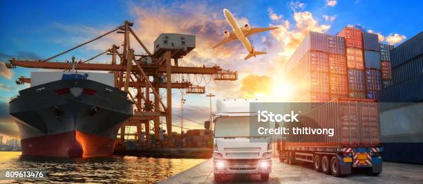 Logistics And Transportation Of Container Cargo Ship And Cargo Plane With Working Crane Bridge In Shipyard Stock Photo - Download Image Now