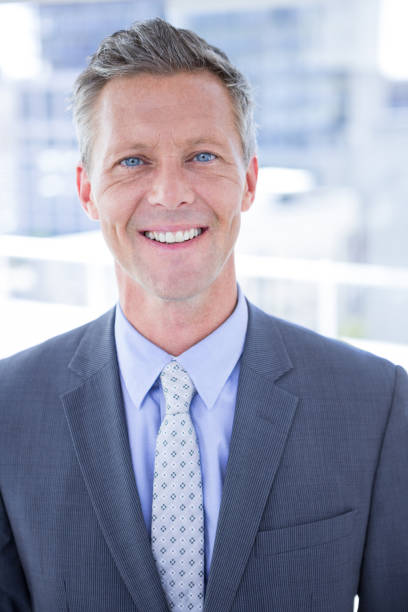 istock Smiling businessman looking at camera 809653958