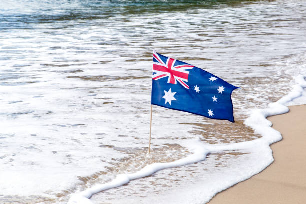 istock Australian Flag waving in the wind on the beach 809657282