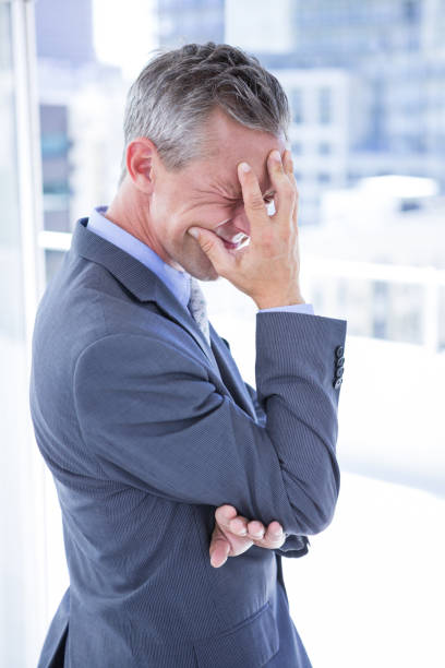 istock Troubled businessman holding his head 809659922