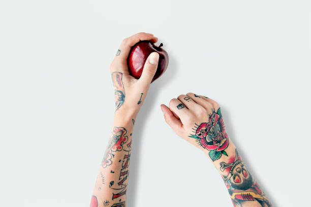 tattoo apple fruit red fresh sweet juicy concept - arm tattoo imagens e fotografias de stock