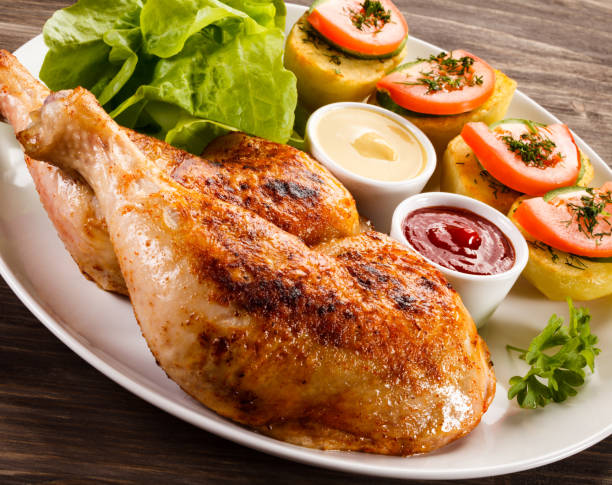 istock Roast chicken leg and vegetables 809693686