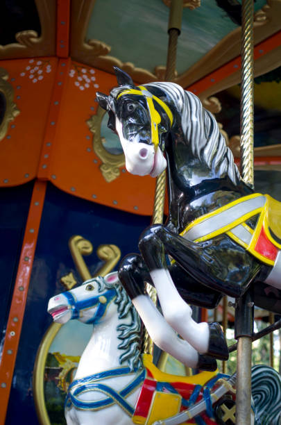 istock Two colorful carousel horses on funfair 809750194