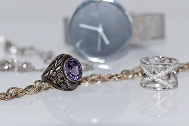 istock Silver ring and chain on the background of watches 809794804