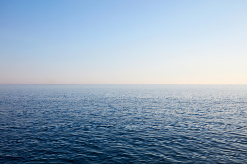 Mediterranean blue, calm sea and horizon, clear sky in Italy