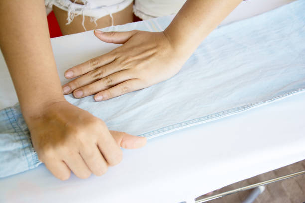istock Woman ironing cloth on board 809811858