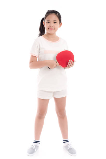 Beautiful Asian girl  playing table tennis on white background isolated