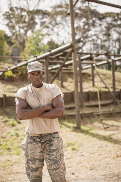 istock Military man standing with arms crossed during obstacle course in boot camp 809817280