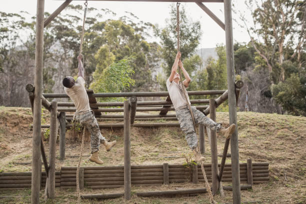 istock Military soldiers climbing rope during obstacle course training 809822308