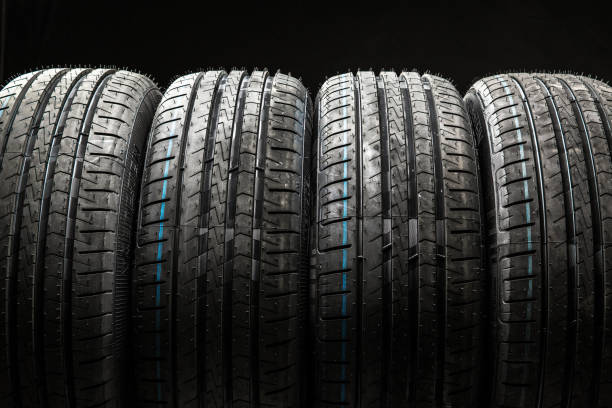 istock Stack of brand new high performance car tires on clean low-key black studio background 809822356