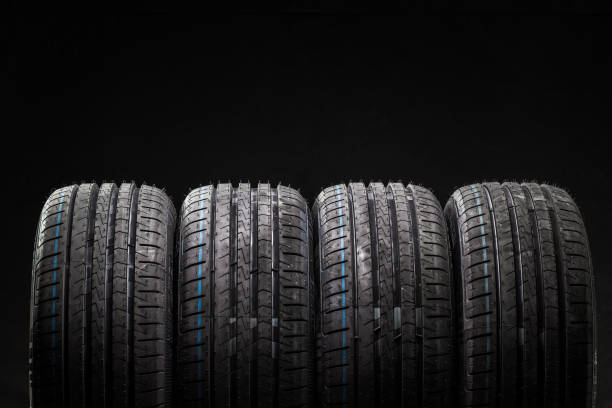 istock Stack of brand new high performance car tires on clean low-key black studio background 809822358