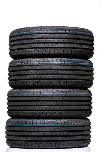 istock Stack of brand new high performance car tires on clean high-key white studio background 809822396