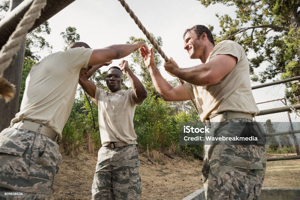 Young Military Soldiers Practicing Rope Climbing During Obstacle Course  Stock Photo - Download Image Now - iStock
