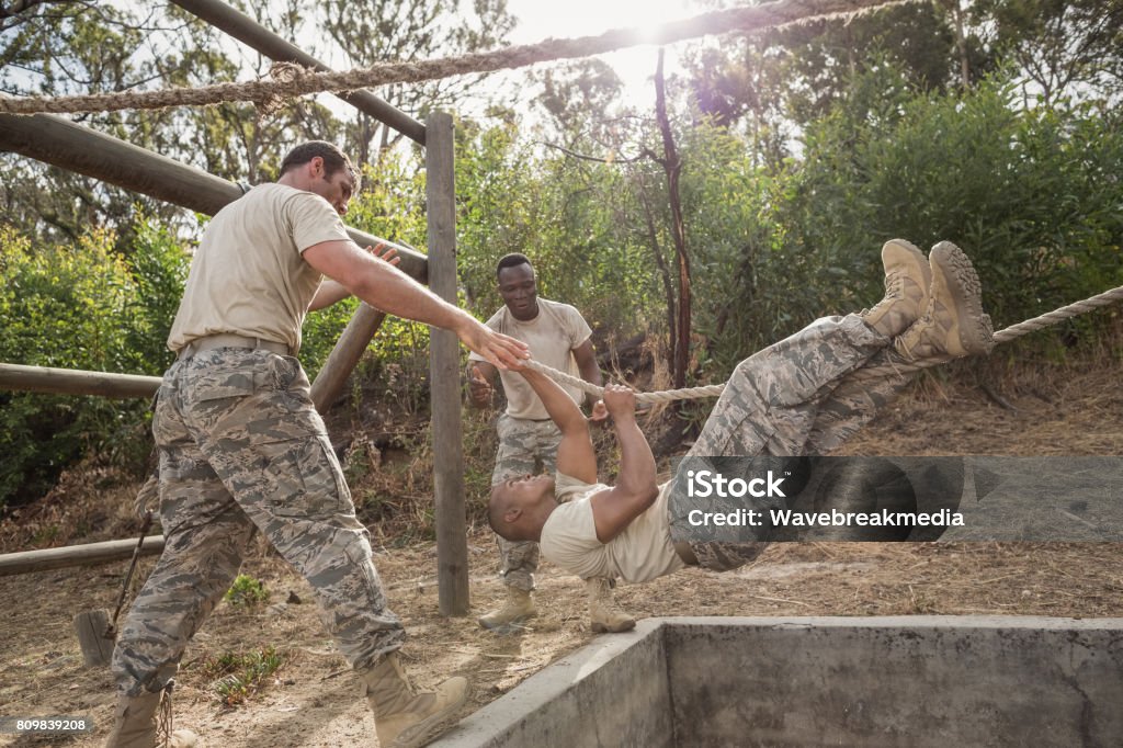 Military Climbing Ropes Training Young Military Soldiers Practicing Rope Climbing During Obstacle Course ...