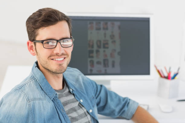 istock Casual male photo editor in front of computer 809842852
