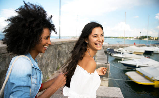 istock Two happy woman friends going for a ride 809848542