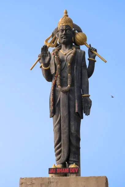 Photo of High statue of the Indian deity Shani with raised hand