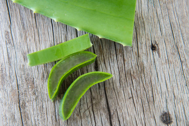 istock Fresh aloe vera on wood texture. 809859900