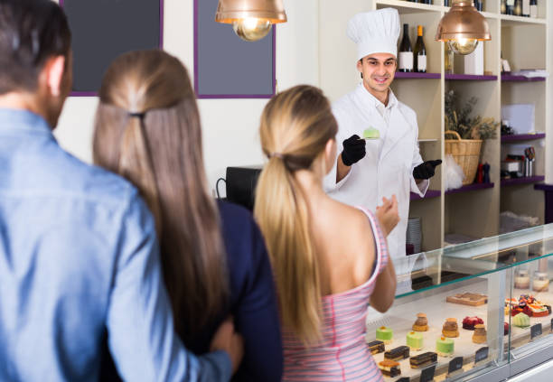 istock Man is offering delicious cakes from showcase 809860016