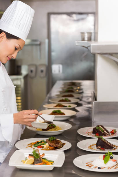 istock Female chef garnishing food in kitchen 809868478