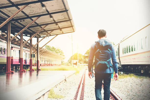 istock Asian young smart man walking on railroad with goal success concept. 809868566