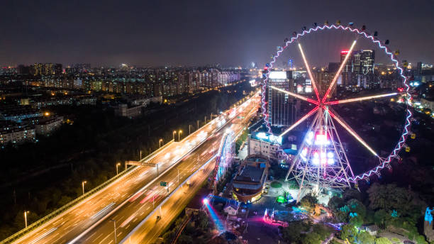 istock city night with big ferris wheel beside the elevated road 809868866